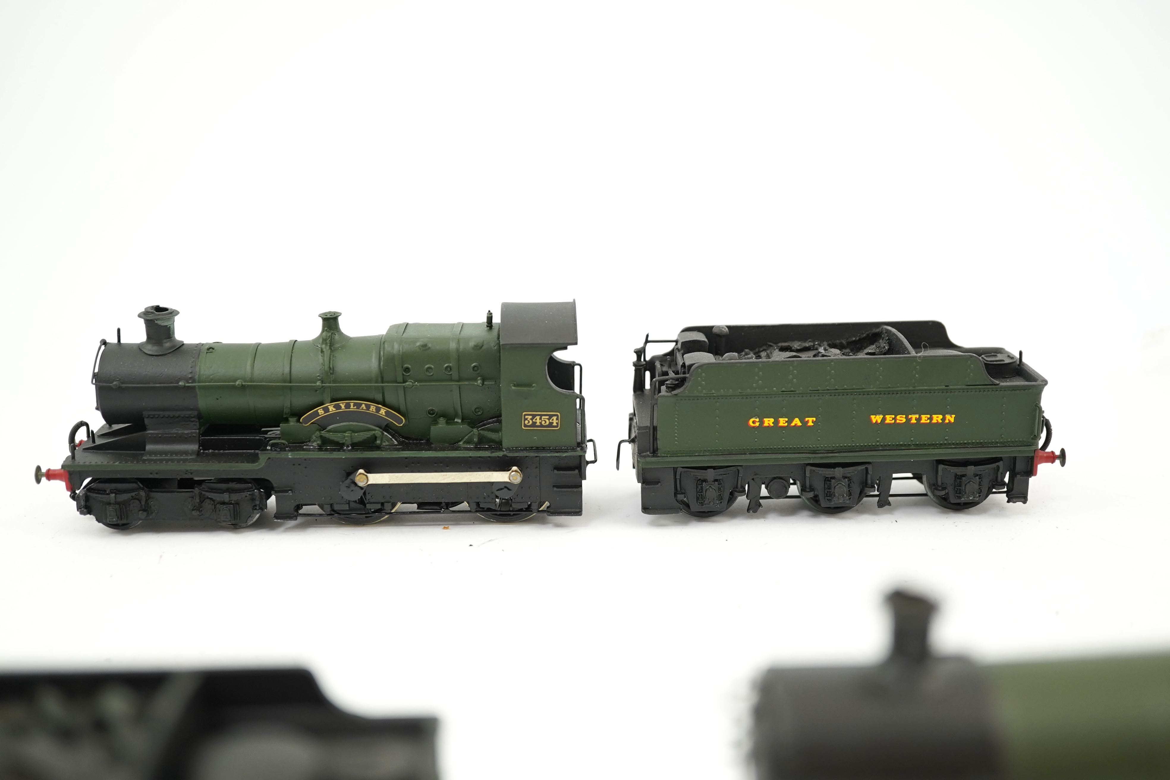 Three 00 gauge brass and white metal kit built GWR tender locomotives; a 2884 class 2-8-0, 2884, together with an 33xx class 4-4-0, 3454, and a War Dept. 2-8-0, 3012, all constructed, painted and lined to a high standard